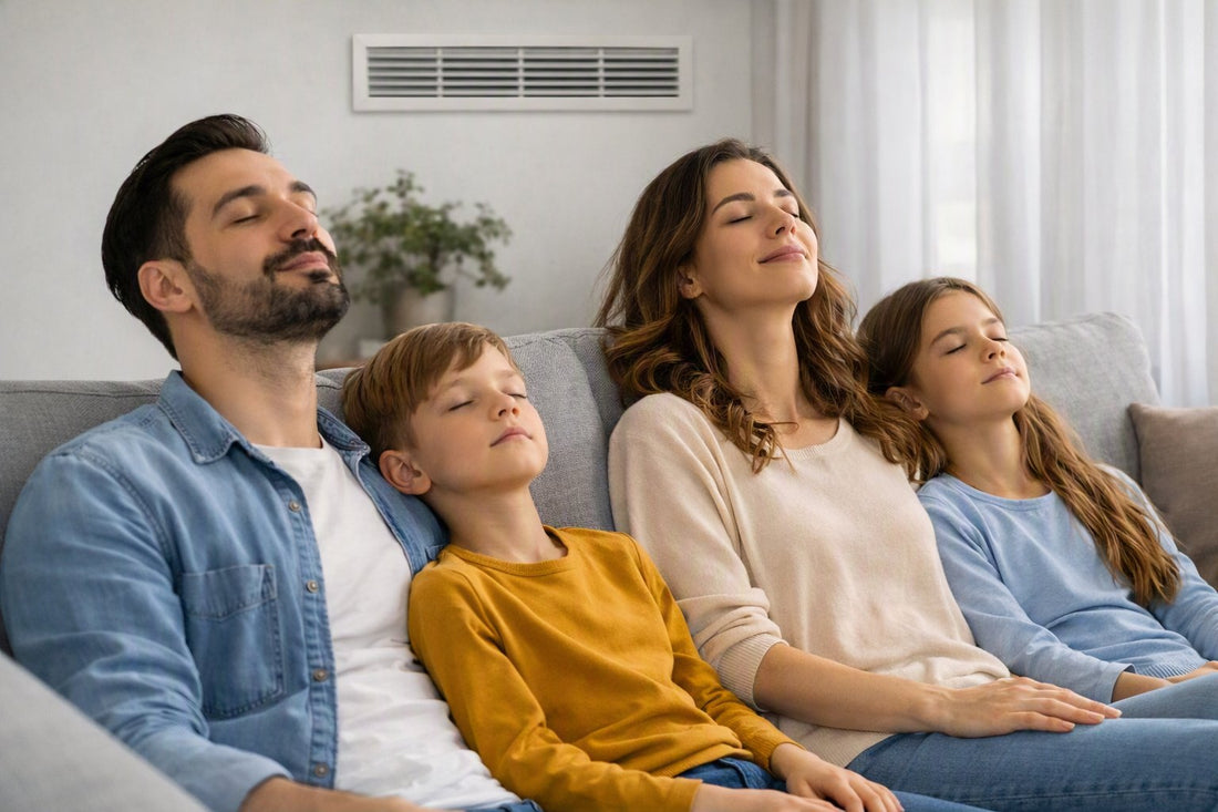 Family relaxing on a sofa in a living room with mechanical ventilation